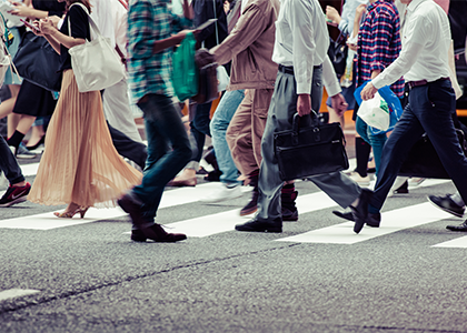 Crowd of people crossing the street at a crosswalk